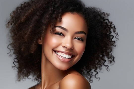 Beauty portrait of dark skinned african american woman smile with clean healthy skin, curly hair