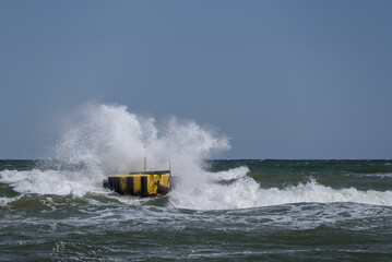 WEATHER BY THE SEA - Wind and foaming storm waves in the sunlight