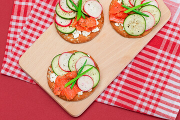 Crispy Cracker Sandwiches with Fresh Salmon, Cucumber, Radish, Cottage Cheese and Green Onions. Easy Breakfast. Quick and Healthy Sandwiches. Crispbread with Tasty Filling. Healthy Dietary Snack