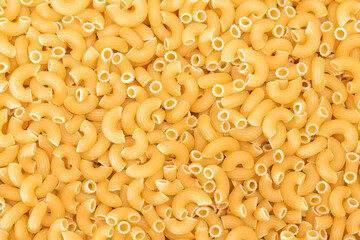 Uncooked Chifferi Rigati Pasta Background. Fat and Unhealthy Food. Classic Dry Macaroni Texture. Italian Culture and Cuisine. Raw Pasta