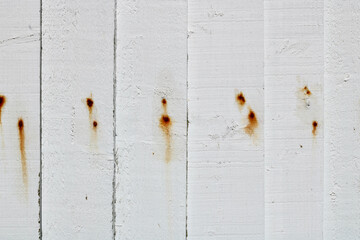 White wooden panelled fence with rust stains and space for copy