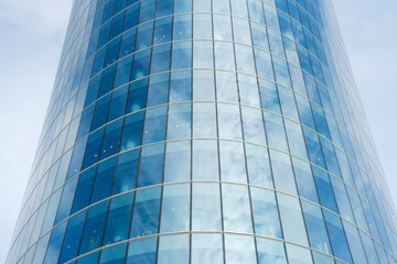 glass building of the business center on the background of the blue sky