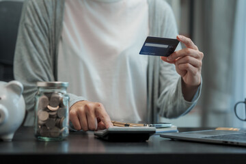 Close up young caucasian woman saving money for household payments credit, cashless, piggy bank, mutual fund, mixed fund, Super Saving Funds (SSF), Retirement Mutual Fund (RMF), Net Asset Value (NAV)