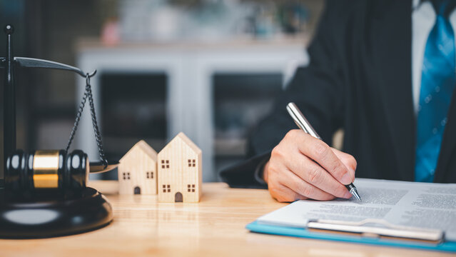 In a divorce business concept, the judge's gavel, law book placed on desk in courtroom represent gravity and seriousness of situation as couples resolve conflicts, reach agreements through legal means