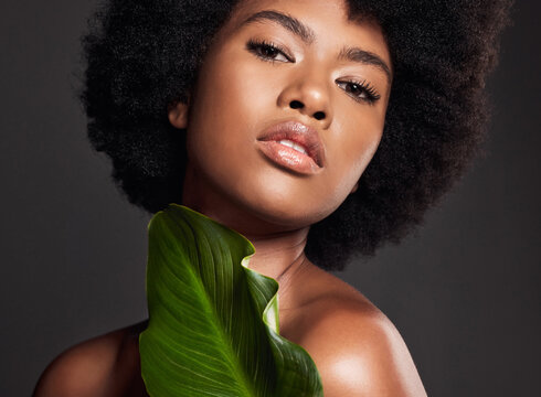 Black woman, face and leaf, natural beauty and eco friendly cosmetics with portrait on studio background. Facial, afro and African female model, skincare and glow with sustainable dermatology