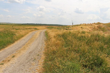 Fototapeta na wymiar A dirt road through a field