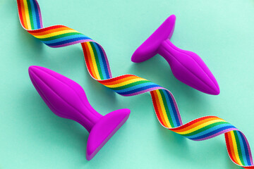 Anal plug and rainbow ribbon as a symbol of LGBT Pride - obrazy, fototapety, plakaty