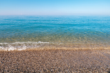 natural background shot of a pebbly beach with no people, no one. Scenic view of empty pebble sea coast on a sunny day