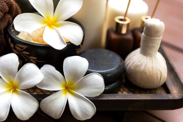 Fototapeta na wymiar Spa beauty massage healthy wellness background. Spa Thai therapy treatment aromatherapy for body woman with flower Plumeria nature candle for relax summer time. Lifestyle and Cosmetic Concept