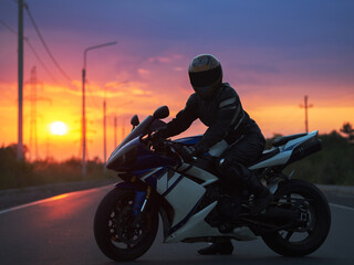 Fototapeta na wymiar motorcyclist on a sports bike at sunset