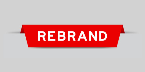 Red color inserted label with word rebrand on gray background