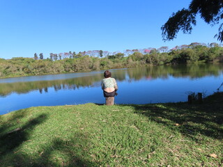 Fototapeta na wymiar person on the bank of lake