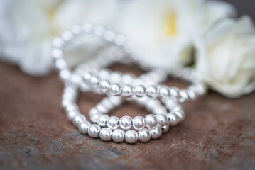 The photo shows hematite beads. This is a natural stone painted in different colors, round and hexagonal. 