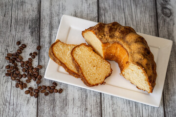 fresh cut cake decorative on a plate with coffee beans