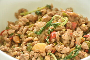  spicy stir fried chop pork with chili and basil leaf on bowl