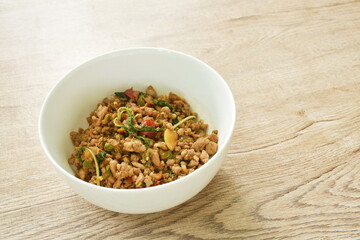  spicy stir fried chop pork with chili and basil leaf on bowl