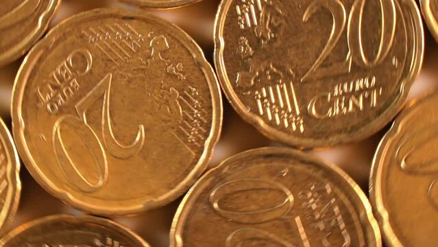20 Euro Cent Coins, Rotating Money Background - Top View, Macro. Euro Money Currency. A Lot of Twenty Cent Cash. Golden Eurocents. Business, Finances and Money Saving Concept - Rotation Right