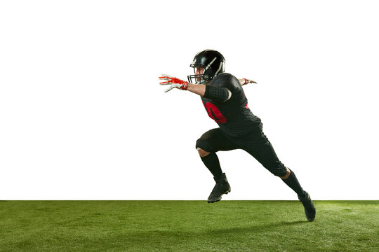 Dynamic image of man in black uniform and helmet, american football player in motion, running on field over white background. Professional sport, action, lifestyle, competition, training, ad concept