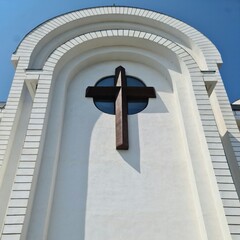 A cross on a white building