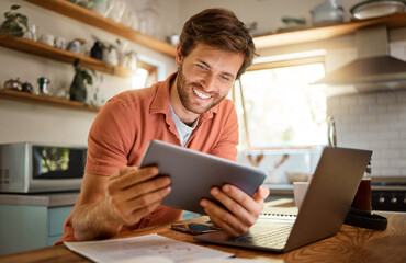 Technology, happy man with tablet and laptop for remote work in kitchen of his home with a lens flare. Social networking or connectivity, online communication and male person smile for email - obrazy, fototapety, plakaty