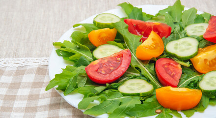 Obraz na płótnie Canvas Fresh salad with tomatoes, rucola and cucumbers