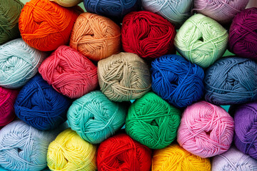 Background of multi-colored skeins of cotton yarn stacked on top of each other. Materials for...