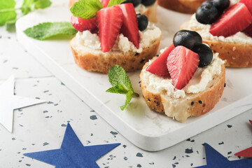 American flag sandwich with strawberries, blueberries, whipped sweet cream, soft cheese on toast bread. 4th of July American Independence Day food. Independence or Patriotic Day breakfast idea Mock up