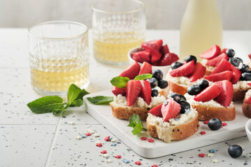 American flag sandwich with strawberries, blueberries, whipped sweet cream, soft cheese on toast bread. 4th of July American Independence Day food. Independence or Patriotic Day breakfast idea Mock up