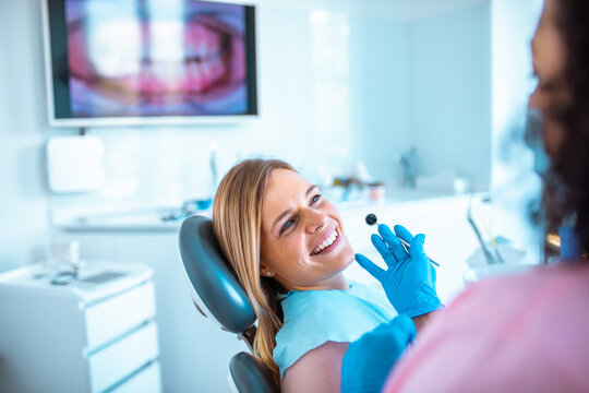 Female dentist working on a female patients teeth in her dental office