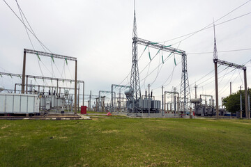 Fototapeta premium Transformers, switches, insulators: equipment used to step up or step down voltage in a high voltage power plant.