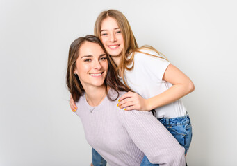 Confident mother and daughter standing in studio