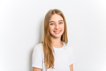 teenage girl in white shirt on a wall background