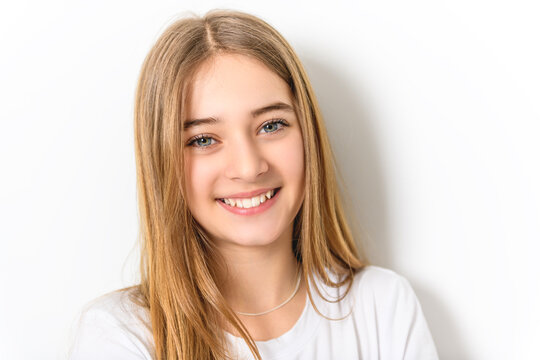 teenage girl in white shirt on a wall background