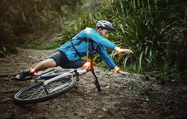 Man, mountain bike and woods with falling, ground and fitness for training, workout and red glow...
