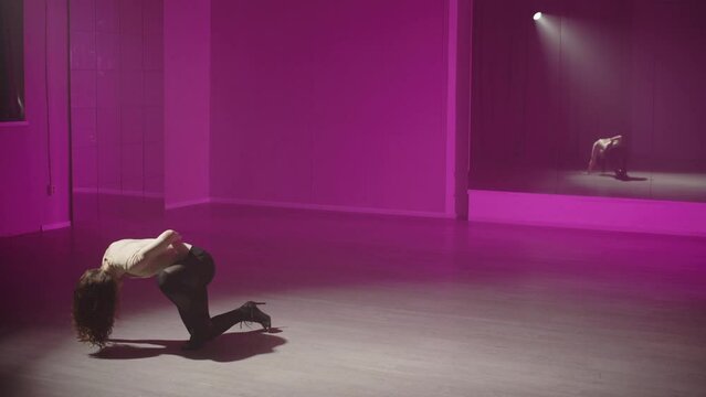 Sexy dance improvisation in pink on white light. Reflection of active movements in the mirror. High quality 4k footage