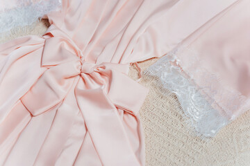 details of a pink nightgown without a person. seams on a silk women's nightgown.