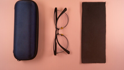 glasses, a case for glasses and microfiber for wiping glasses lie on the table