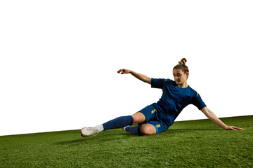 Concentrated female athlete, young girl, football player kicking ball in motion on field grass...