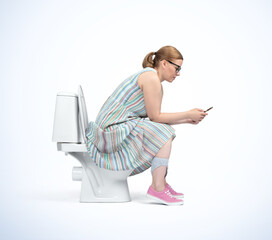 A young woman in glasses and colorful dress on the toilet and looks at her smartphone, side view,...