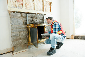 Inspector with white helmet inspecting an old house to be sure everything is well build