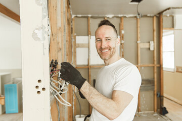 male electrician works working on a old house