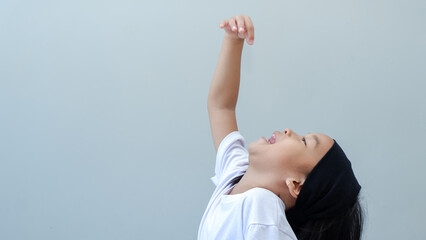 asian young girl pretending put in something to the mouth