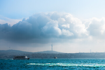 Tourist ship on the Boshporus in Istanbul, Turkey. Big cloud over Asian part of Istanbel