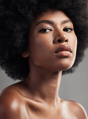 Black woman, serious face and skincare for beauty in studio isolated on a gray background. Natural...