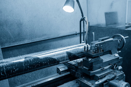The lathe machine finish cut  large size metal shaft parts with liquid coolant method.