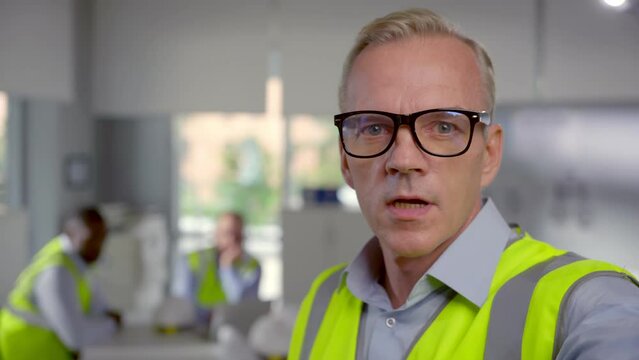Mature foreman looking at camera and talking having video call.