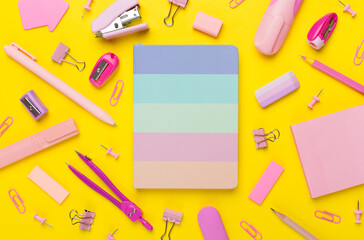 Pink school stationery on color backgroung, top view