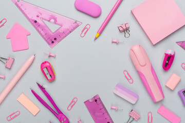 Pink school stationery on color backgroung, top view