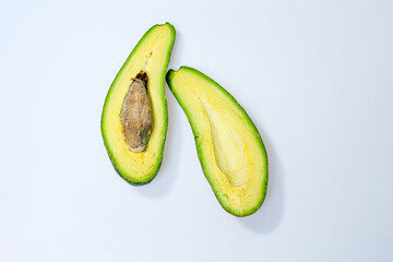 Green avocados on a white background