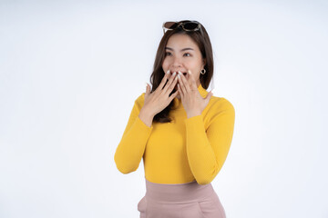 Shocked young woman covering mouth with hands isolated on white background